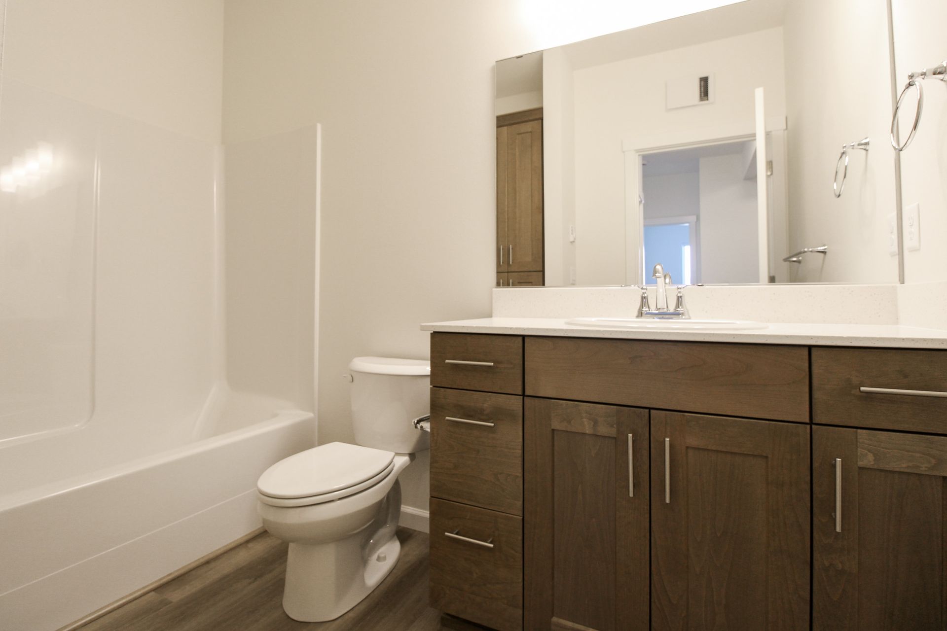 A bathroom with a toilet , sink , and bathtub.