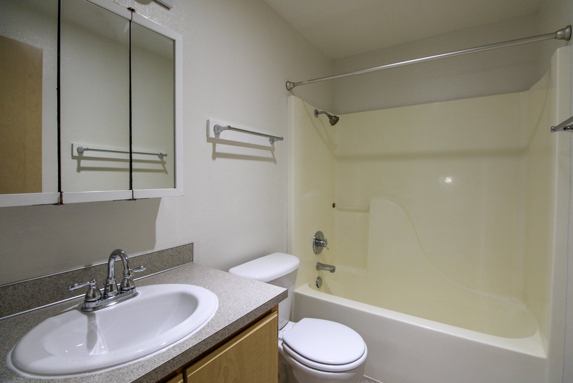 A bathroom with a sink , toilet and bathtub