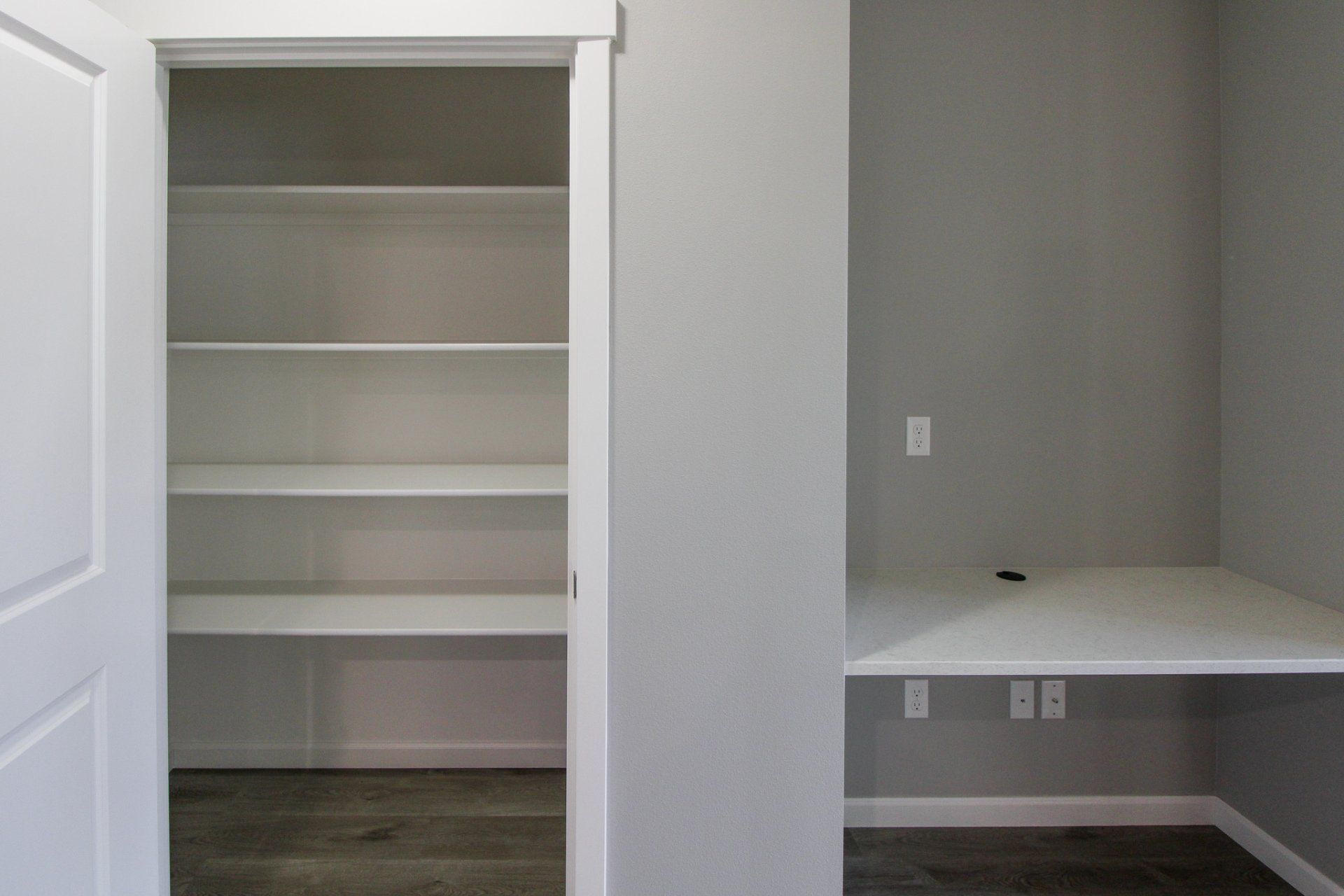 A room with a closet and a desk in it.