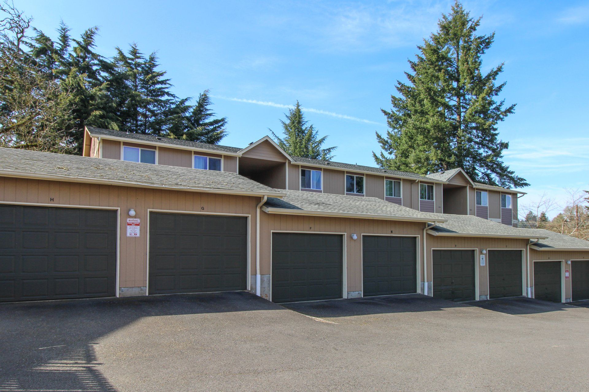 A row of garage doors are lined up in front of a building