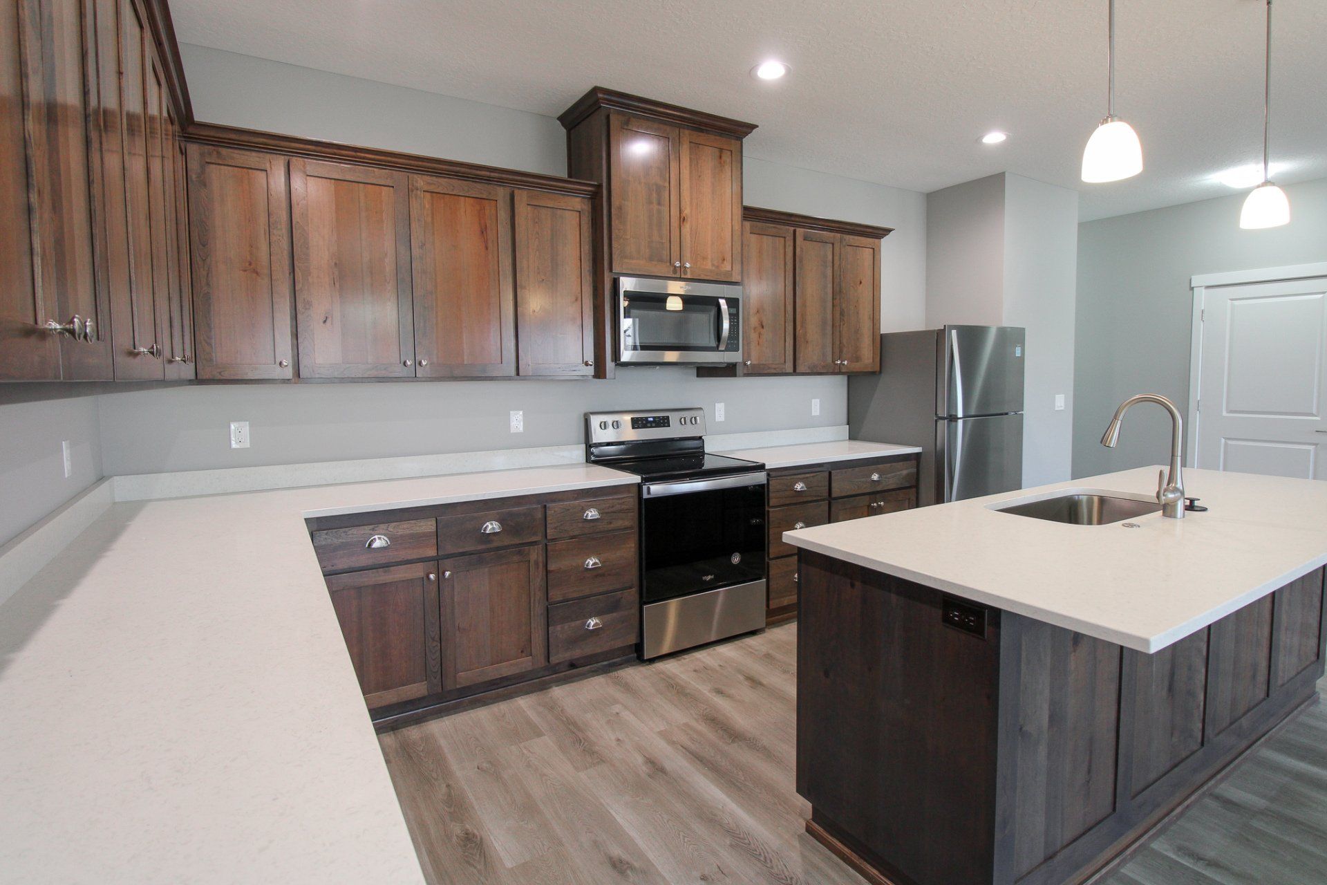 A kitchen with stainless steel appliances and wooden cabinets