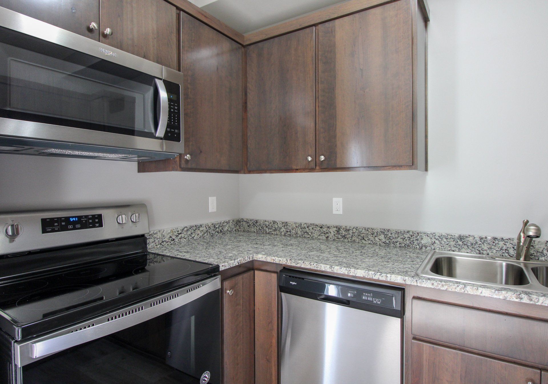 A kitchen with stainless steel appliances and granite counter tops