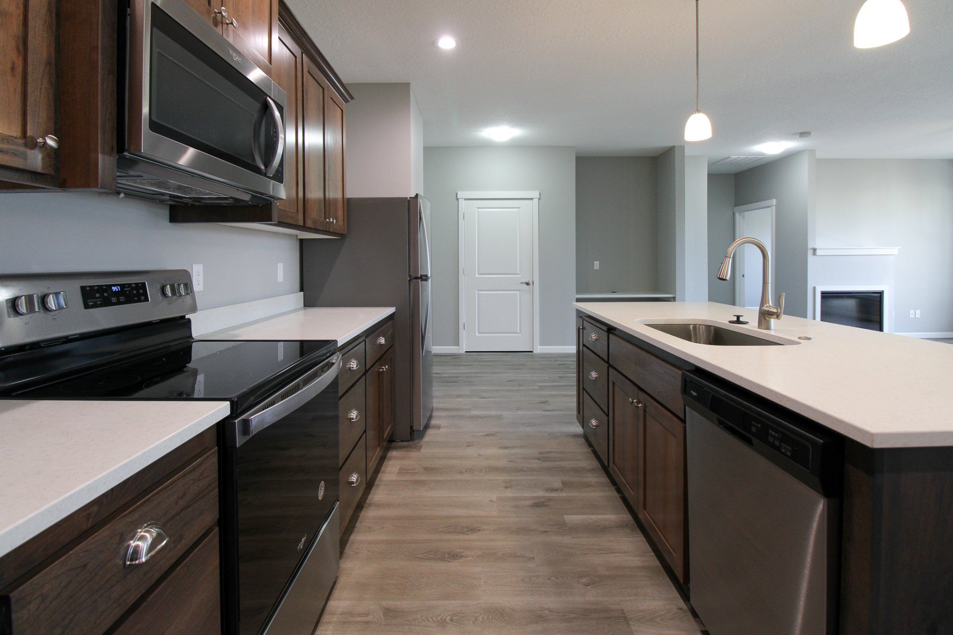 A kitchen with stainless steel appliances and wooden cabinets.