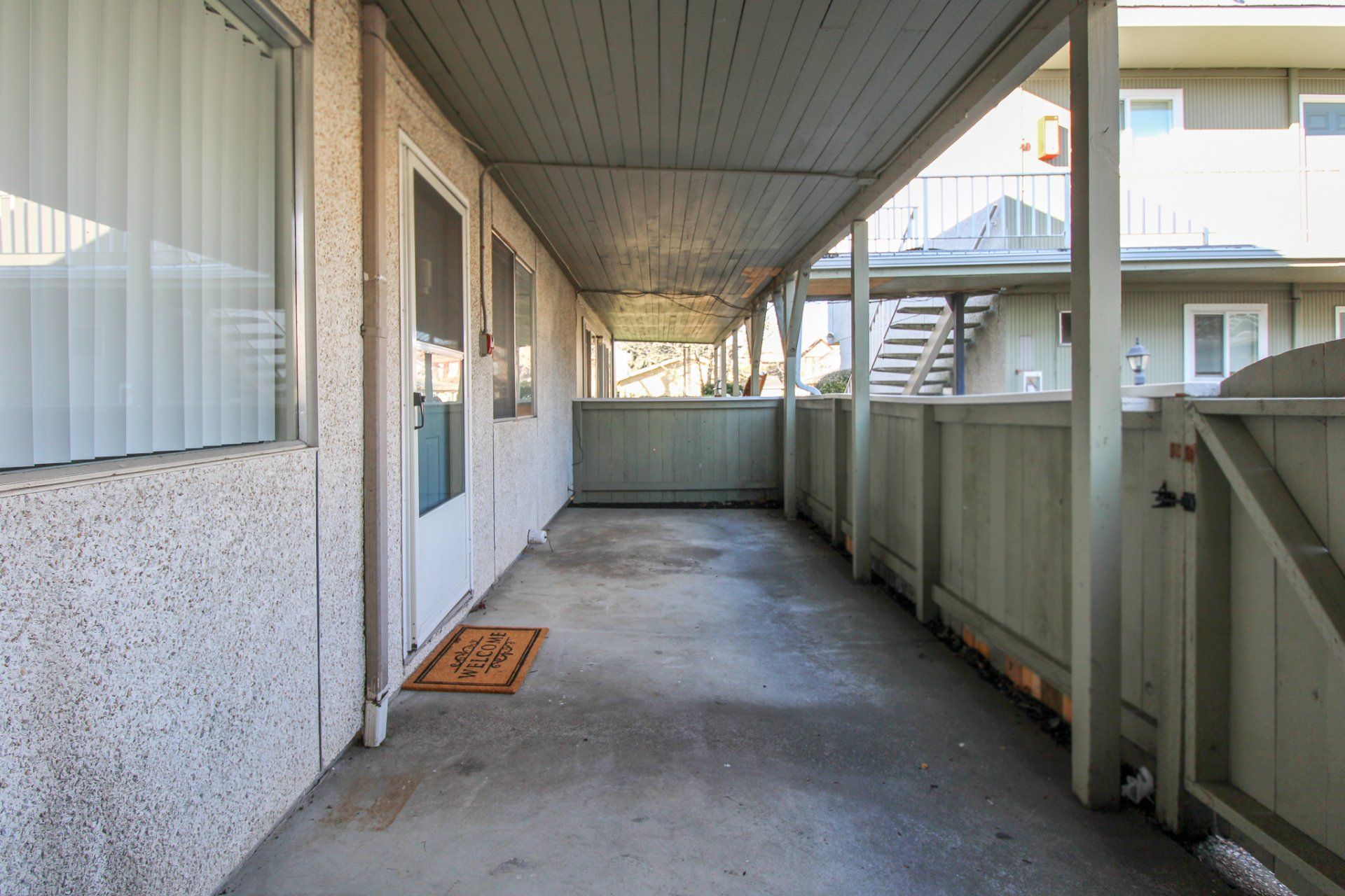 A long hallway leading to a balcony in a building