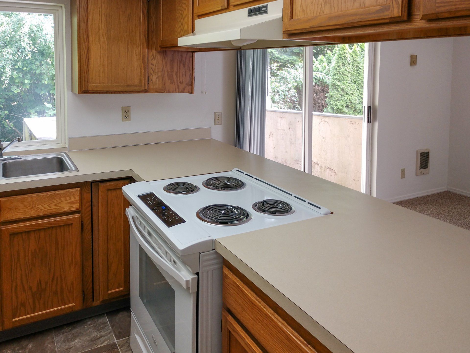 A kitchen with a stove top oven and a sink