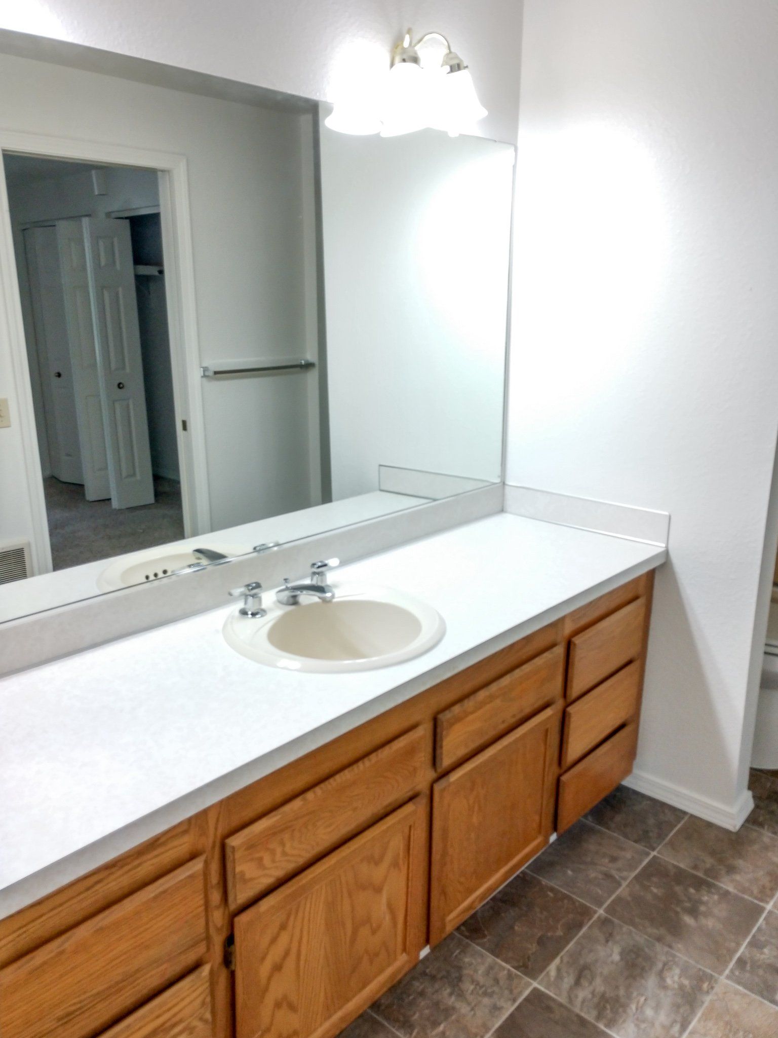 A bathroom with two sinks and a large mirror