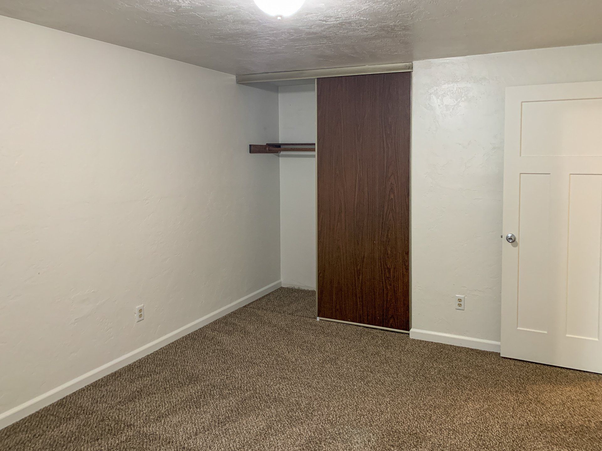 There is a closet in the corner of the room.