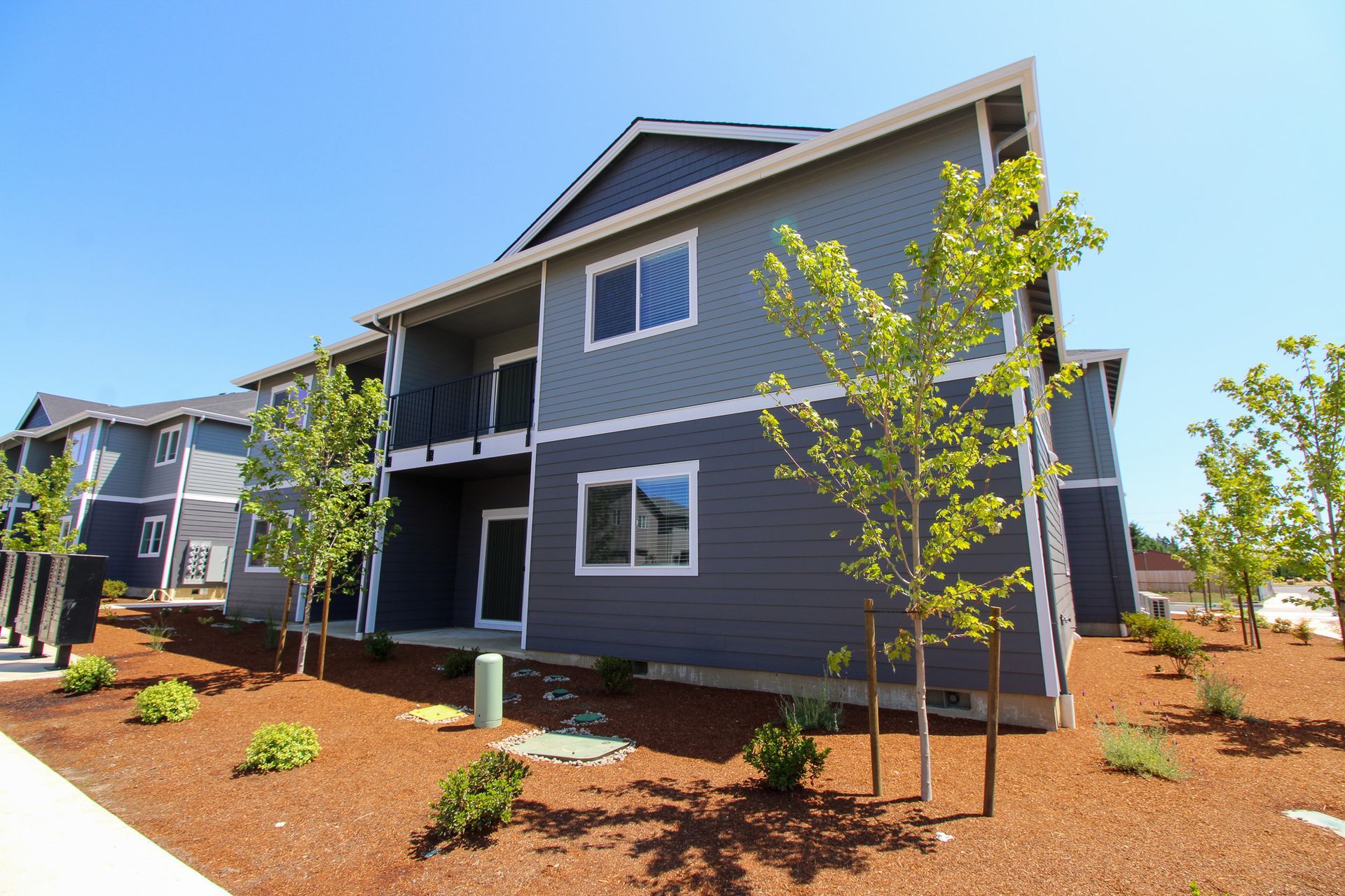 A large apartment building with trees in front of it