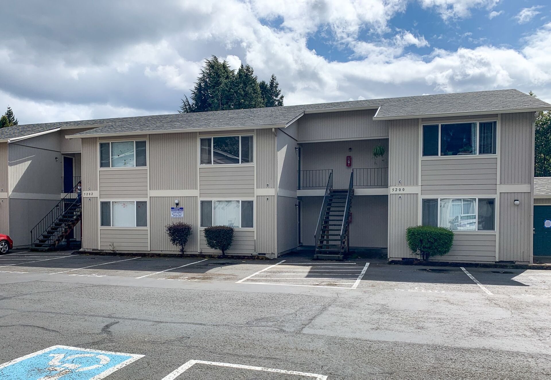 A large apartment building with stairs leading up to the second floor