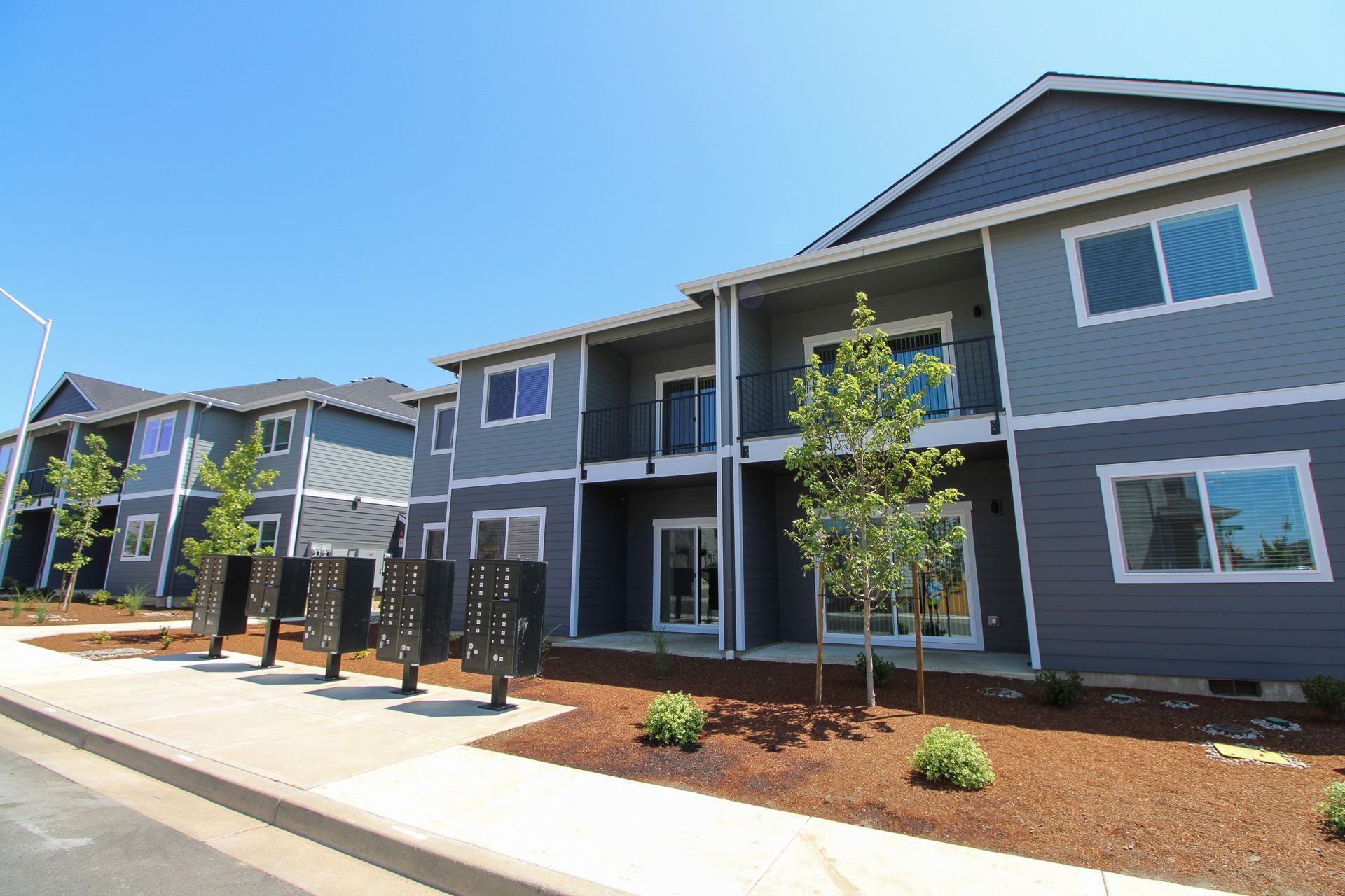 A row of apartment buildings with a blue sky in the background