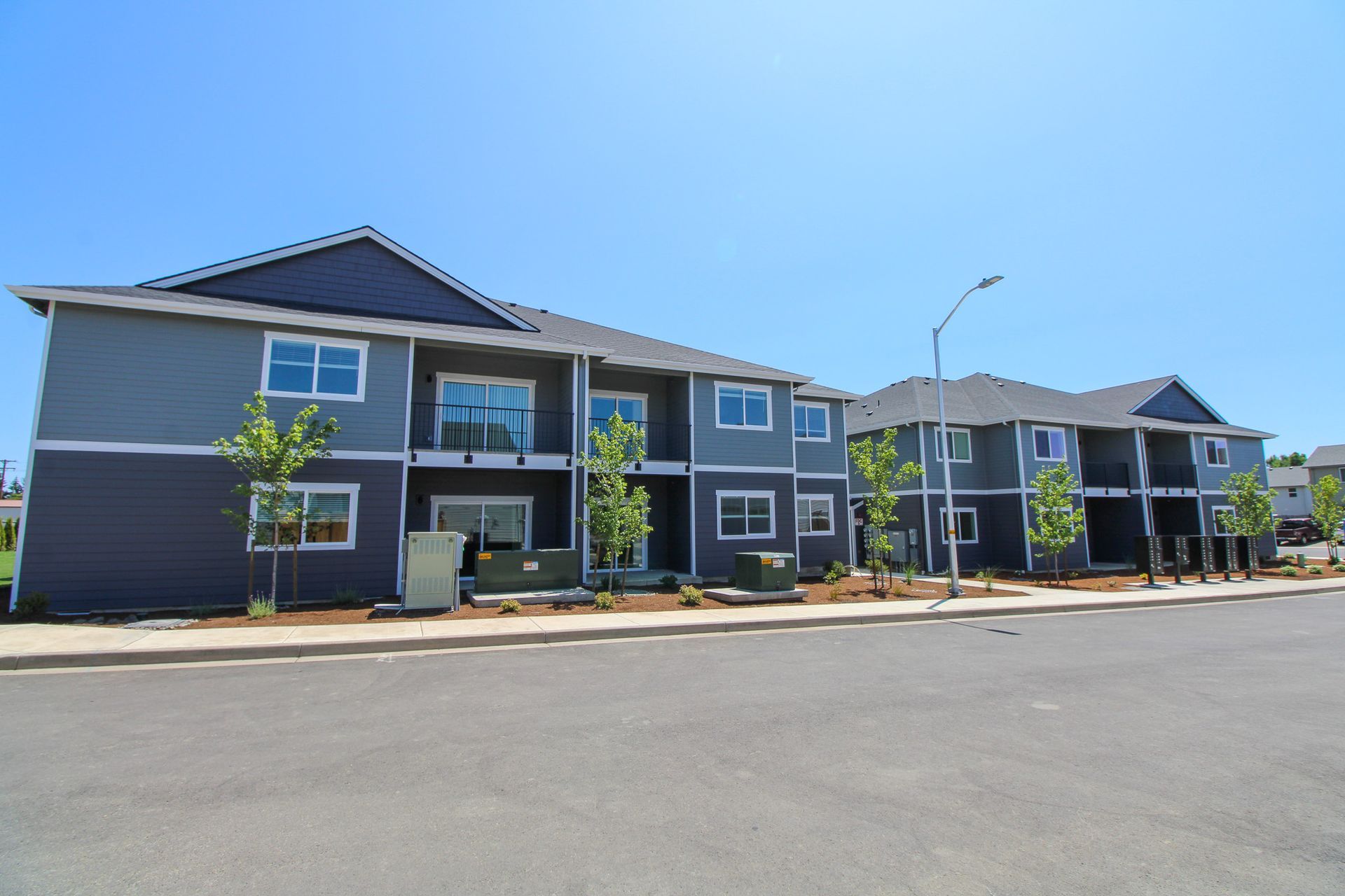 A row of apartment buildings with a blue sky in the background