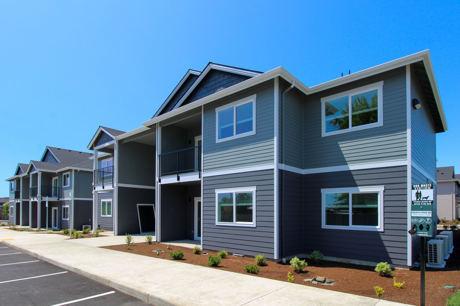 A row of apartment buildings with a lot of windows on a sunny day.