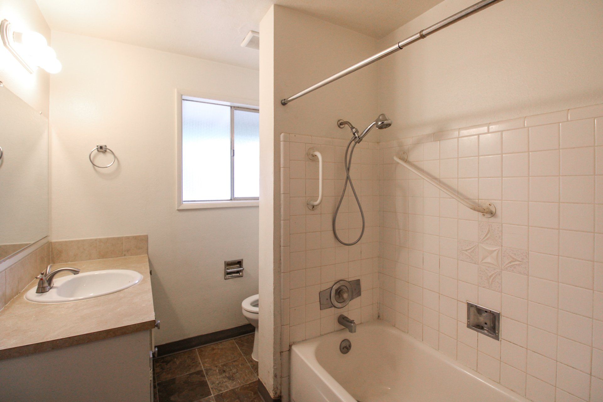 A bathroom with a tub , sink , toilet and shower.