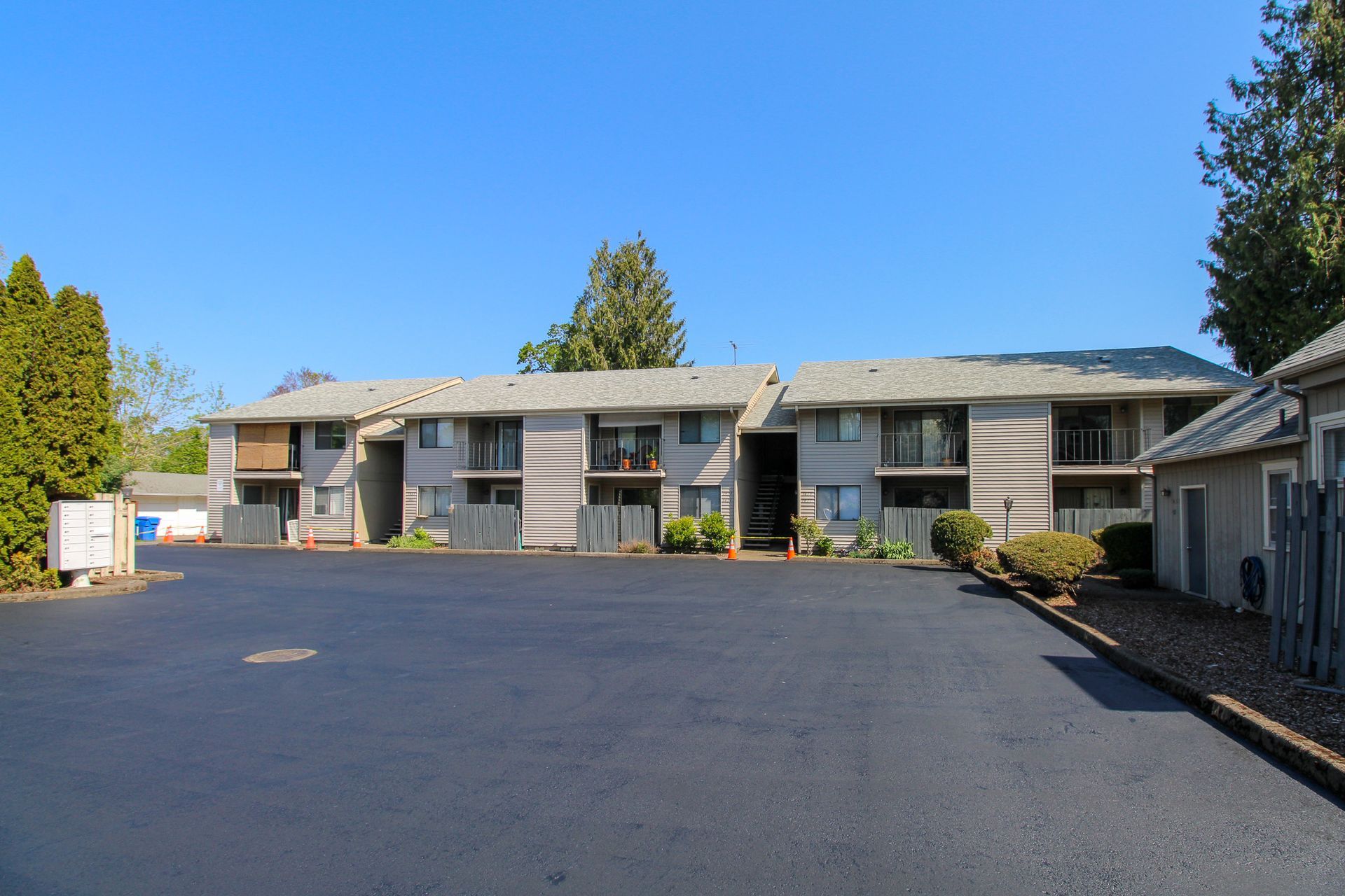 A large apartment building with a parking lot in front of it