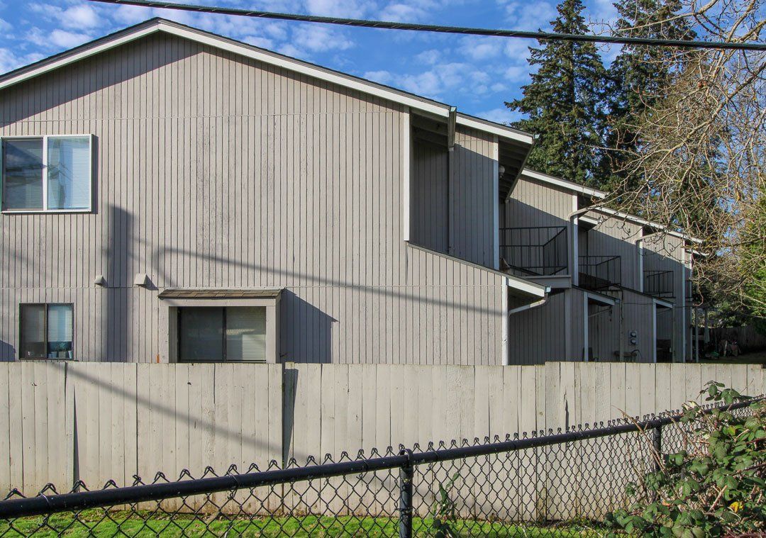 A house with a chain link fence in front of it