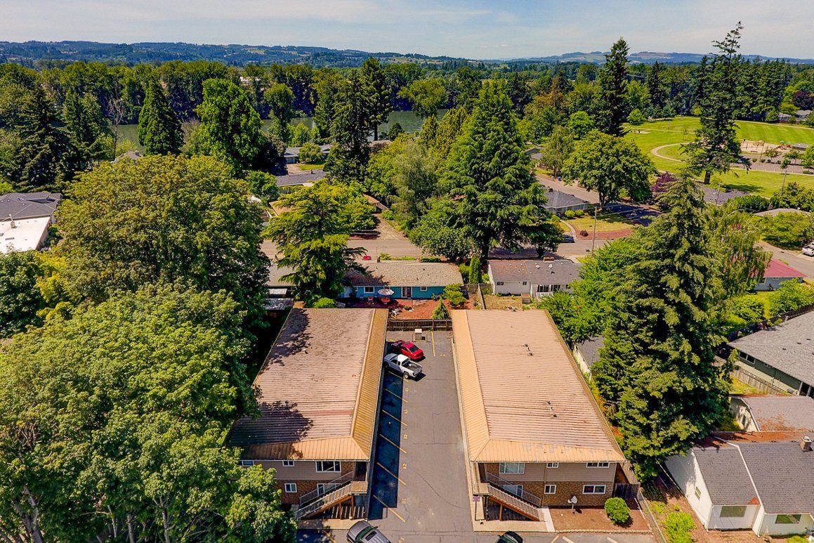 An aerial view of a residential area with lots of trees and houses.