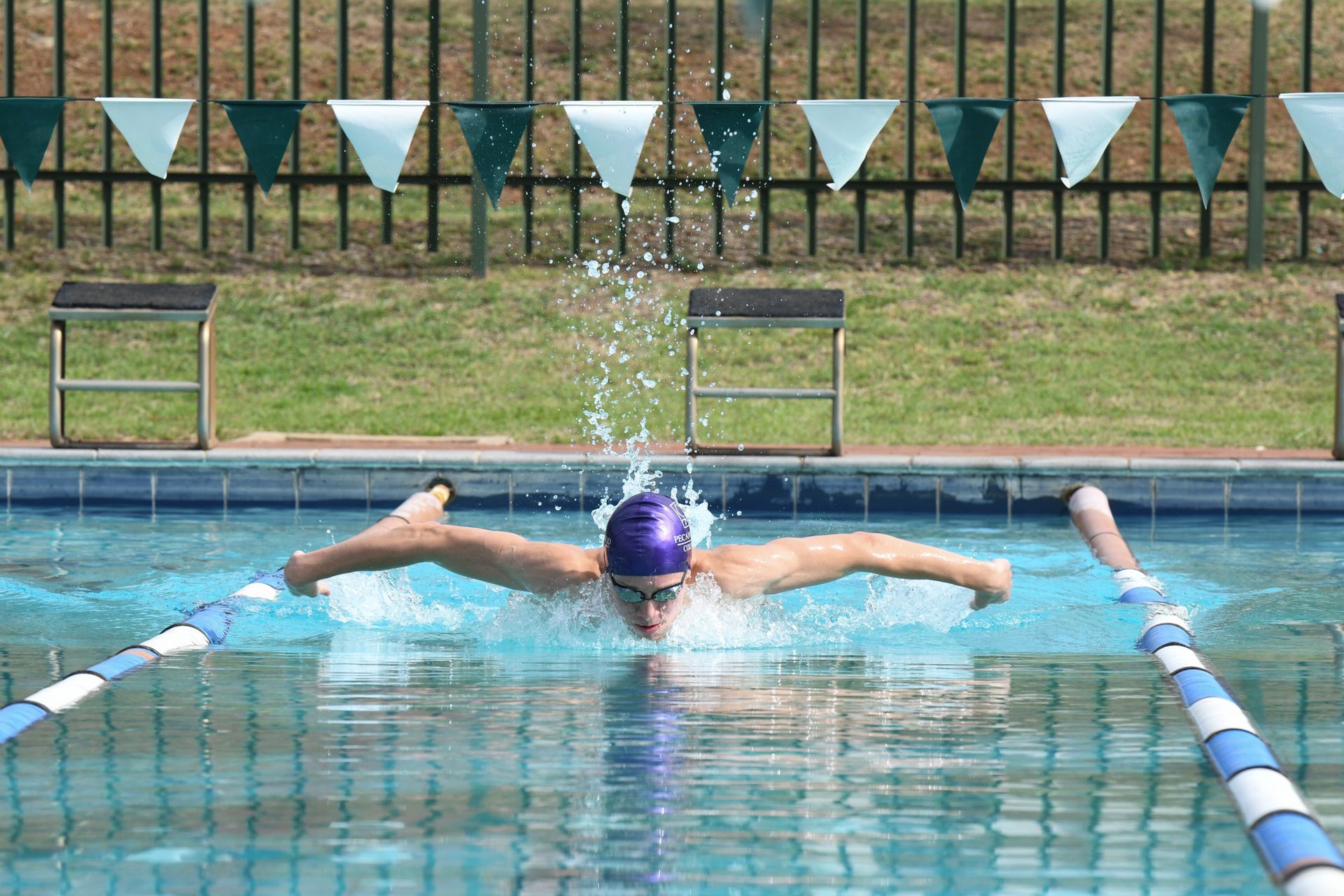 a person is swimming in a pool with a butterfly stroke
