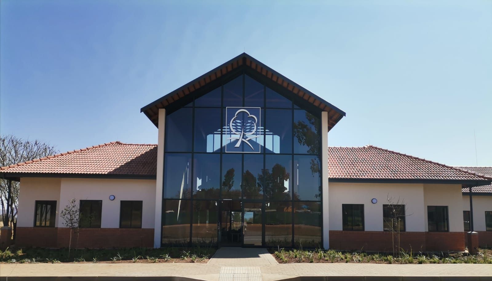 the front of a building with a large glass window
