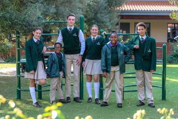 a group of children in school uniforms are posing for a picture