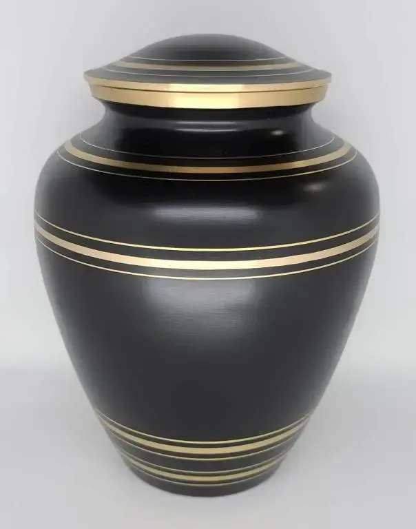 A black vase with gold stripes on it