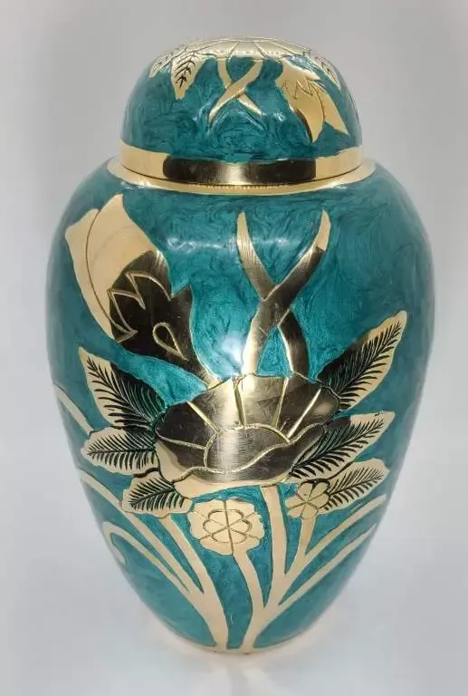 A blue vase with gold flowers on it