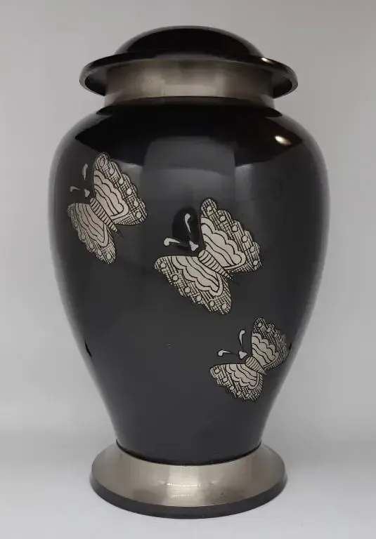 A black vase with silver butterflies on it