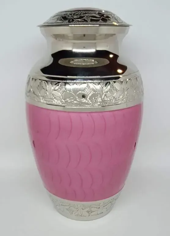 A pink and silver vase is sitting on a white surface.