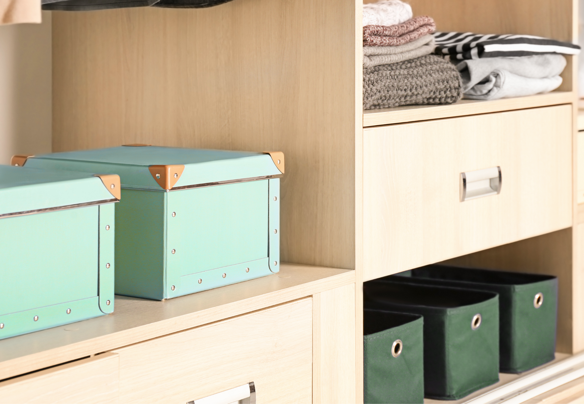 A person wearing blue gloves is cleaning a counter with a cloth and spray bottle.