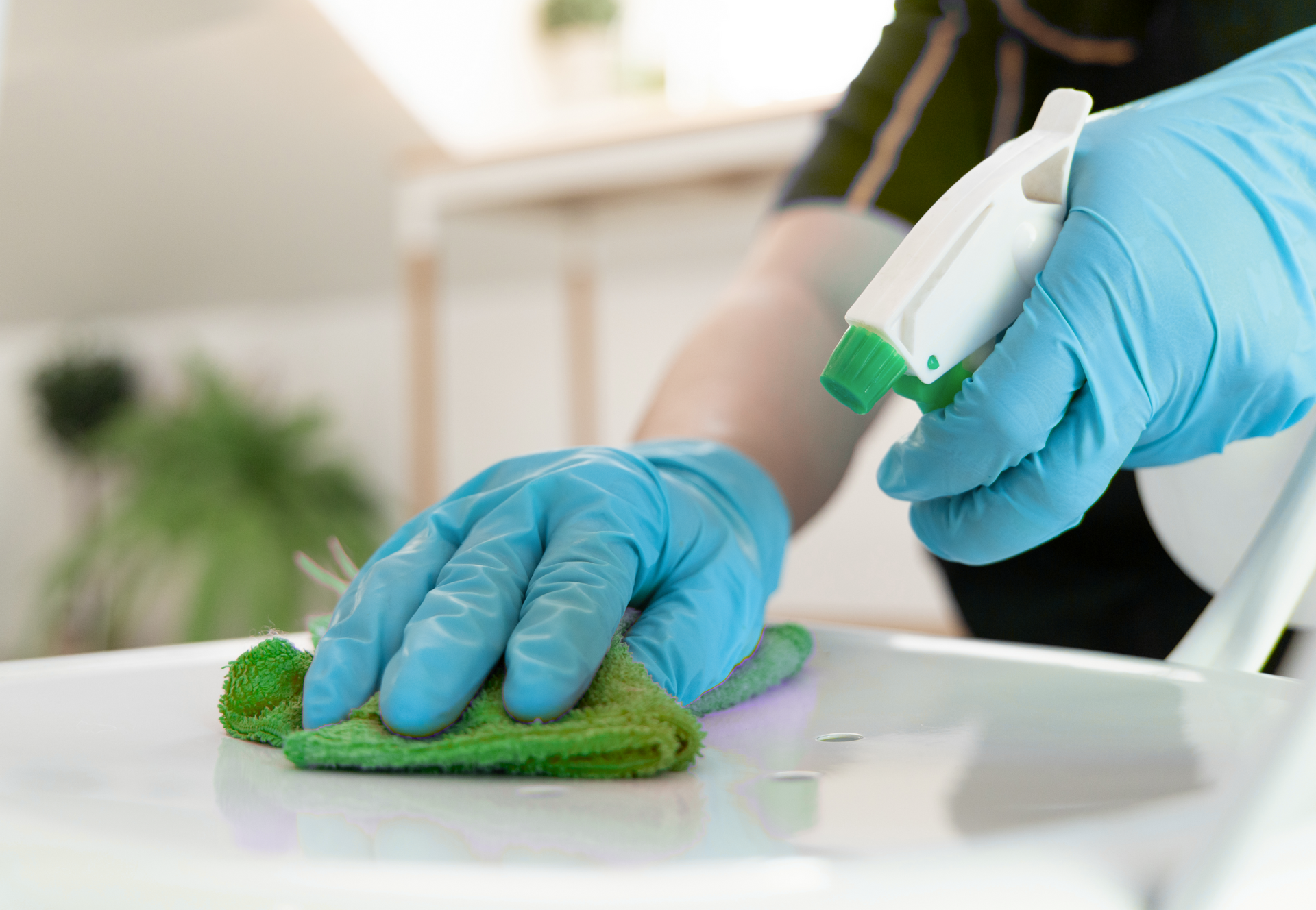 A person is using a yellow vacuum cleaner in a living room.