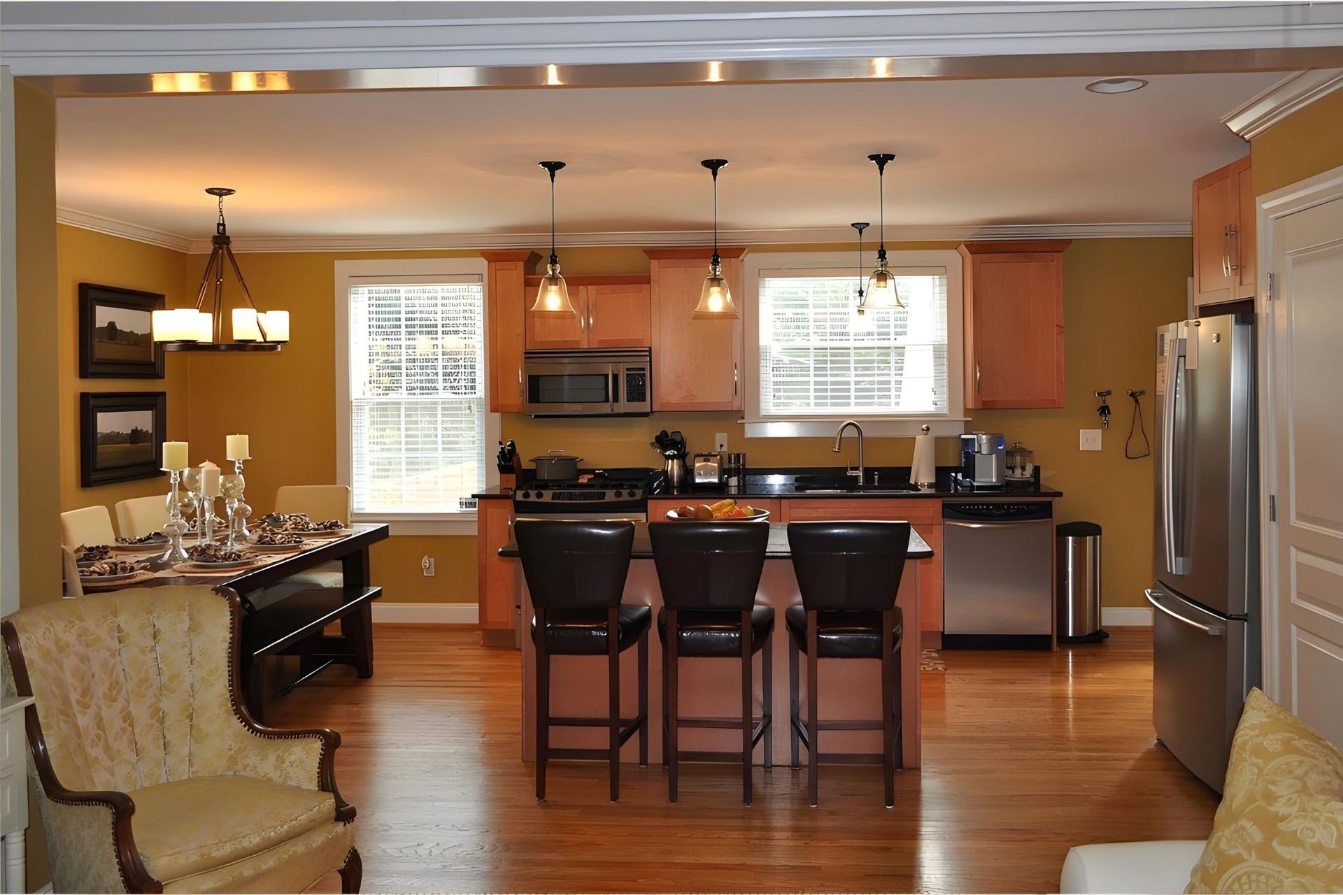 A kitchen with stainless steel appliances and wooden cabinets