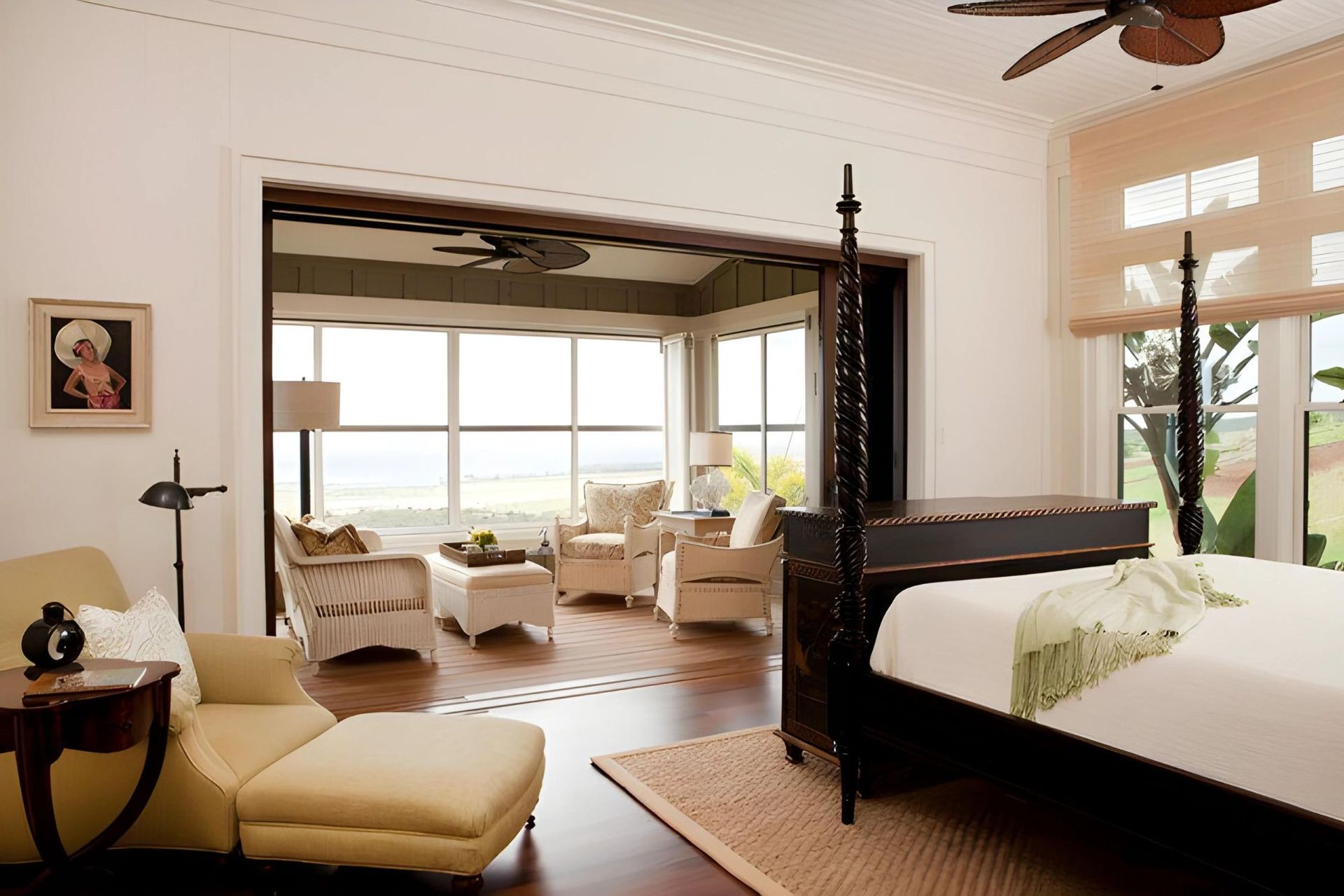 A bedroom with a four poster bed and a ceiling fan