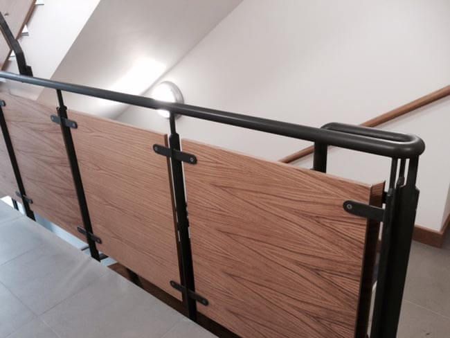 Black metal railing on a wooden staircase