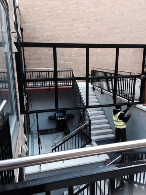 Black and gold simple fencing being installed