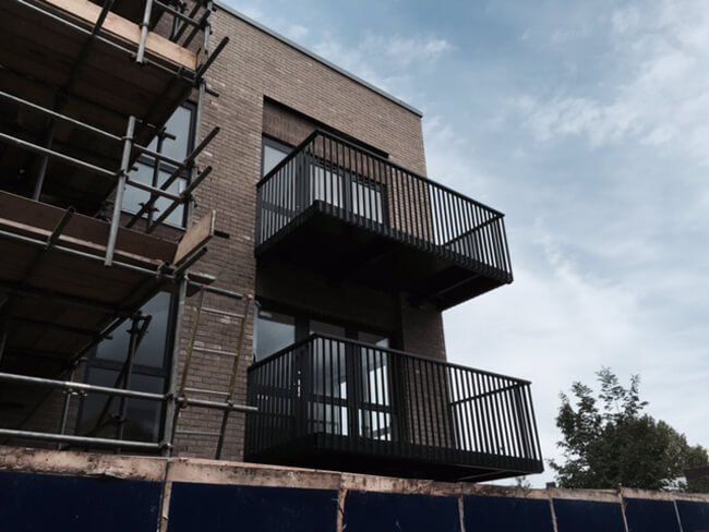 Constructing metal balconies on the exterior of a property