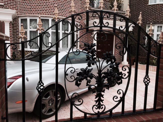 Black and gold metal fencing outside a home