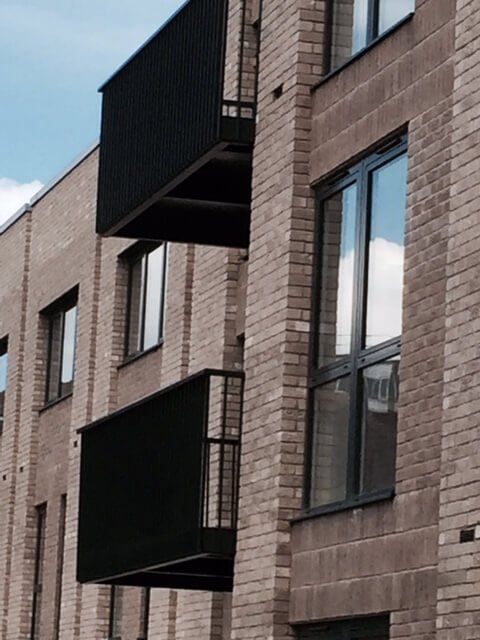Flat block with black metal balconies attached