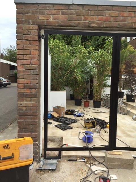 Installing metal gates within a brick archway