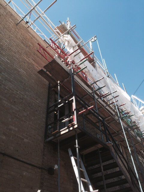 Constructing a metal staircase on the side of a building