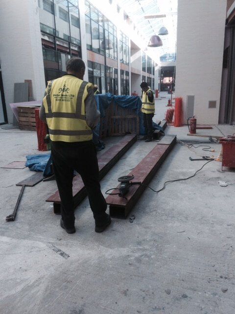 Installing metal beams during a building renovation
