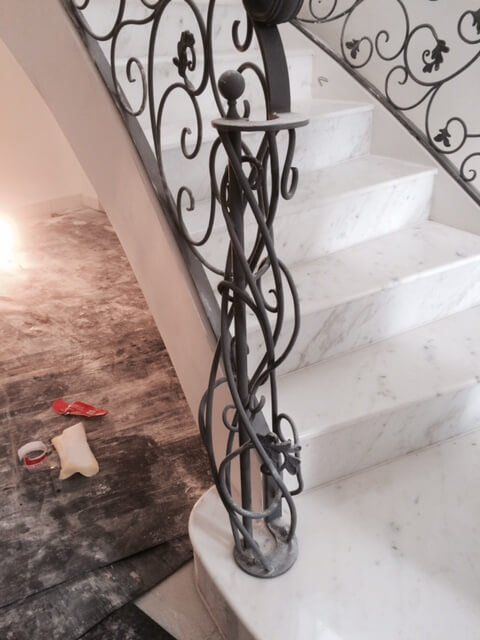 Grand staircase made of marble with elaborate brushed metal handrails