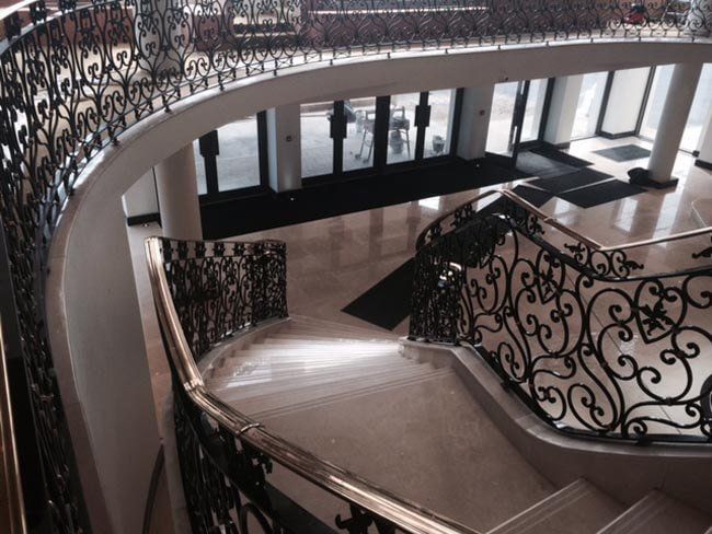 Marble staircase with decorative brushed metal handrail