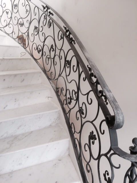 Close up of black floral handrail during construction