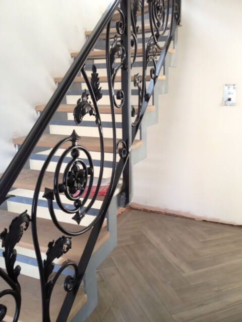 Black handrail with floral detail