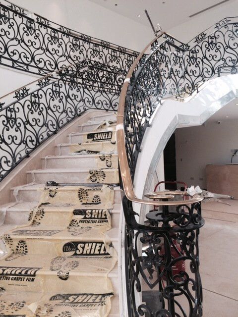 Large black and gold handrail being installed