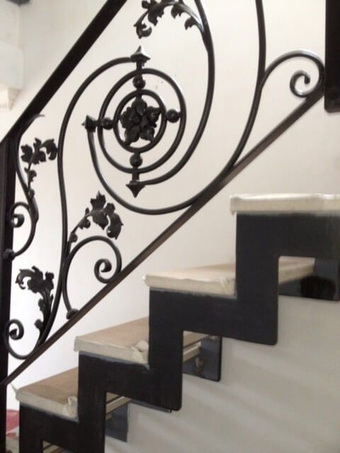 Black staircase walling with floral detail