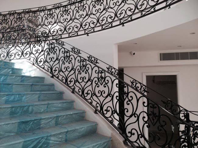 Side view of black detailed handrails during installation