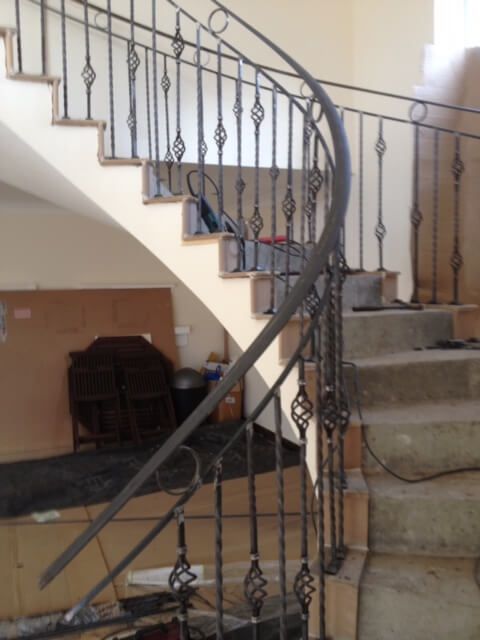 Curved staircase with metal railings