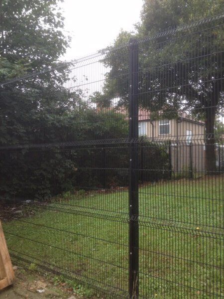 Tall metal fencing around a field