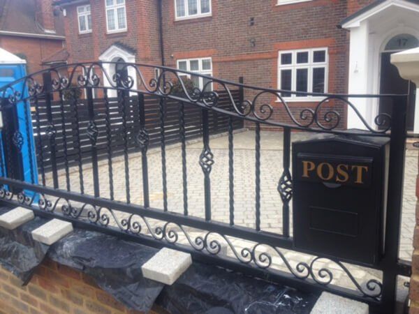 Detailed black fencing outside a home