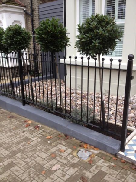 Simple black metal fencing in a garden
